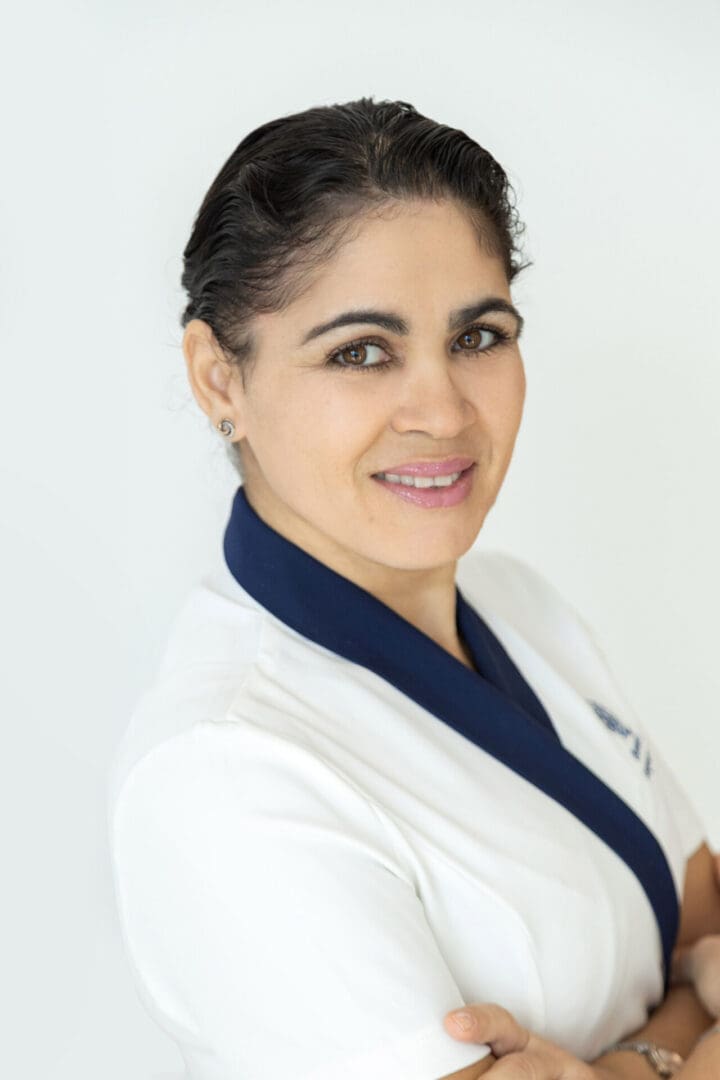 Smiling woman in a white uniform.