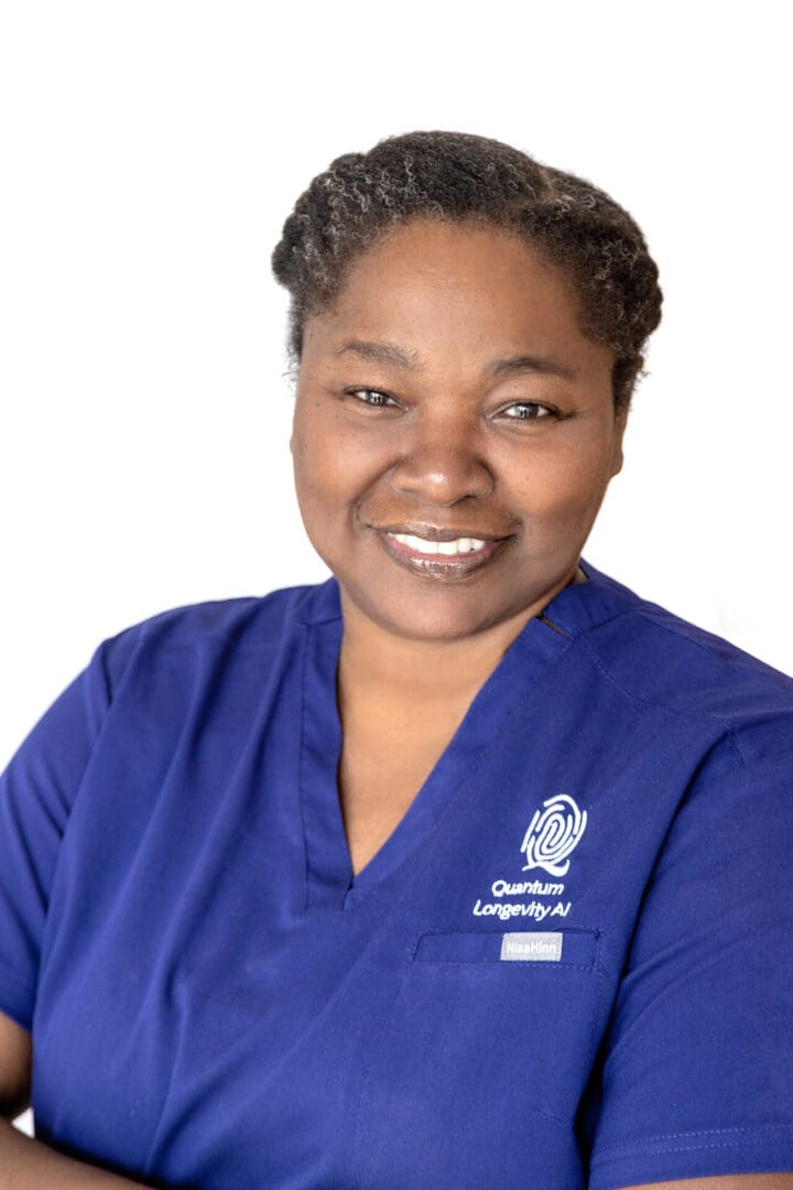 Smiling woman in blue medical uniform.