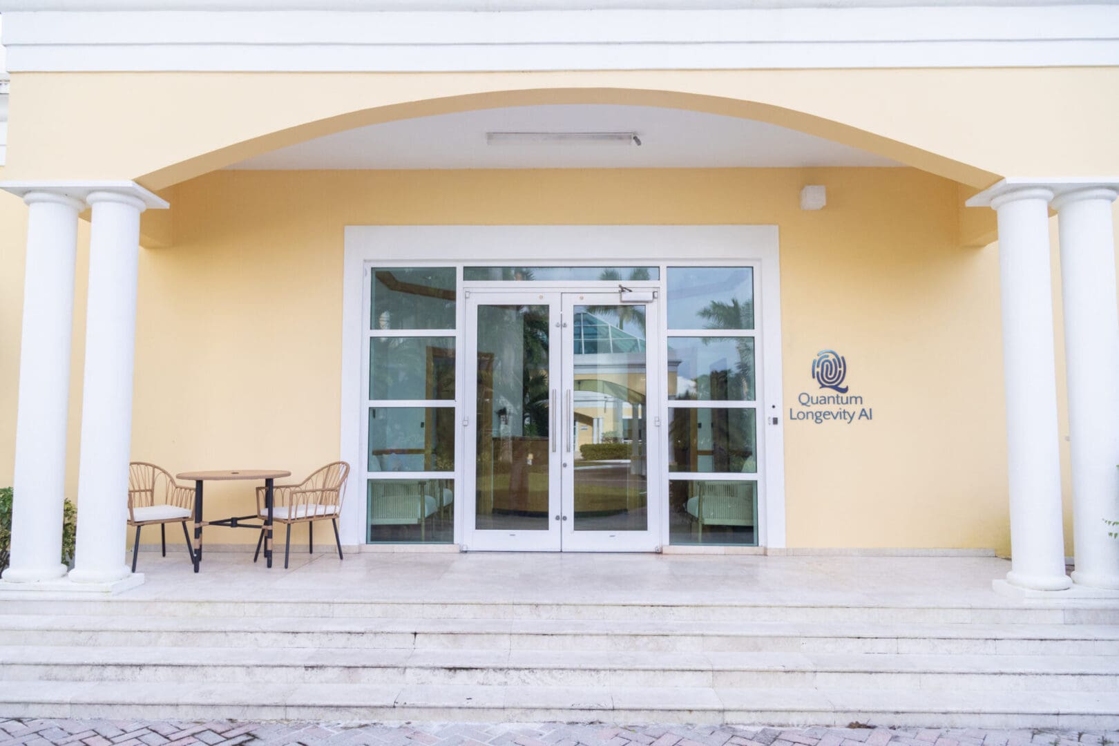 Building entrance with chairs and glass doors.