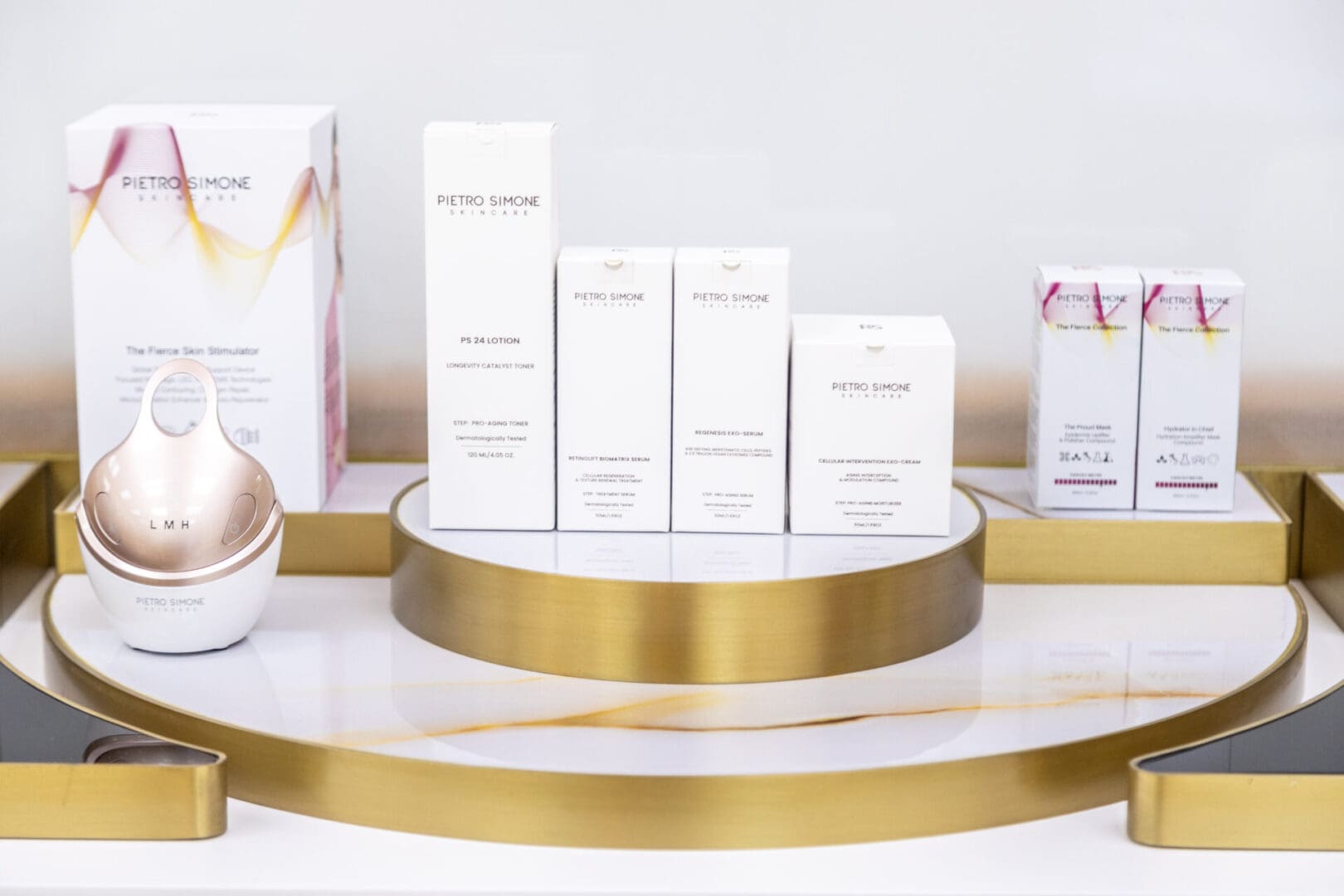 Skincare products displayed on golden tray.