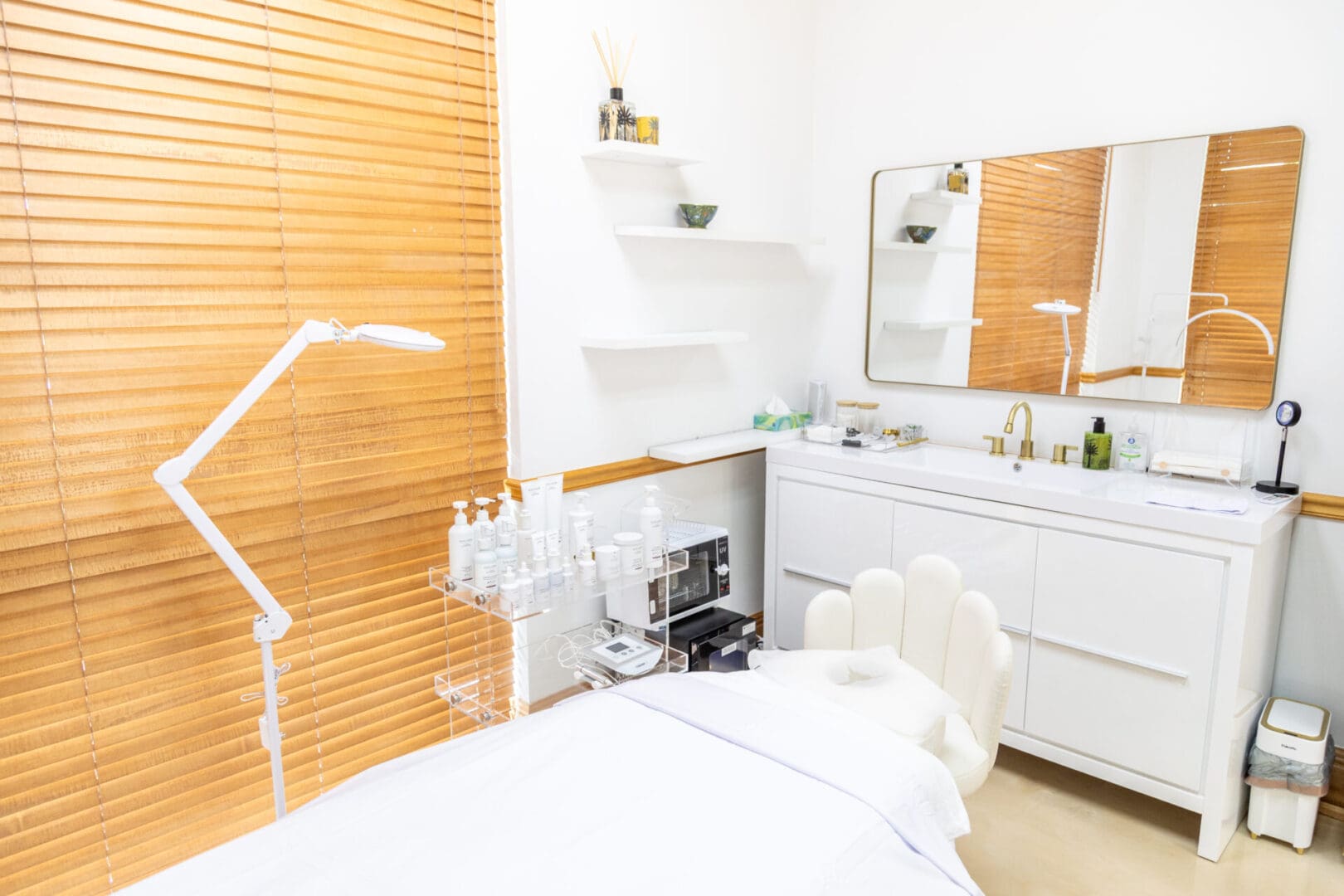 Clean, modern spa room with treatment bed.