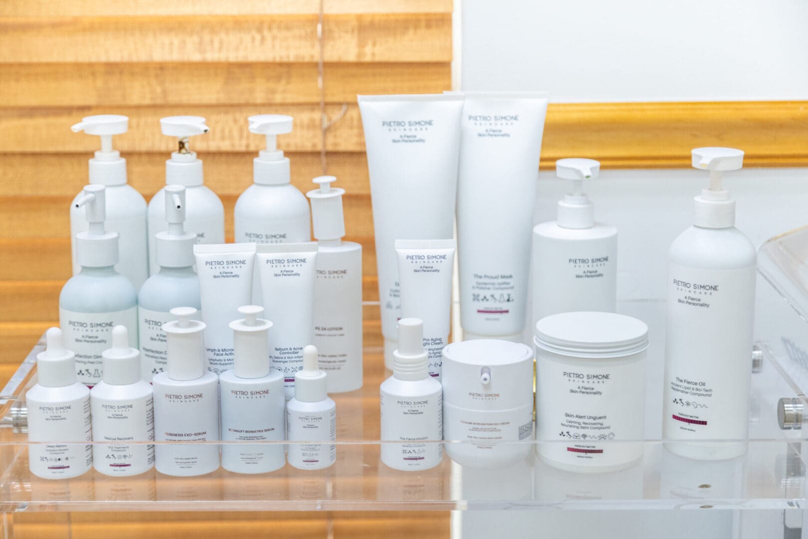 Skincare products displayed on a clear shelf.